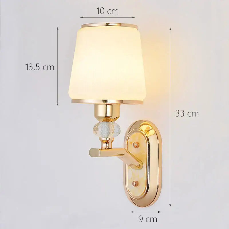 Modern gold crystal bedside wall sconce with frosted glass shade and bead accents for bedroom lighting