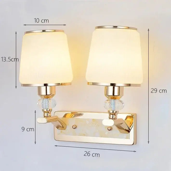 Modern gold crystal bedside wall sconce with cream fabric shades and crystal accents for elegant bedroom decorbites crystal bedside lighting