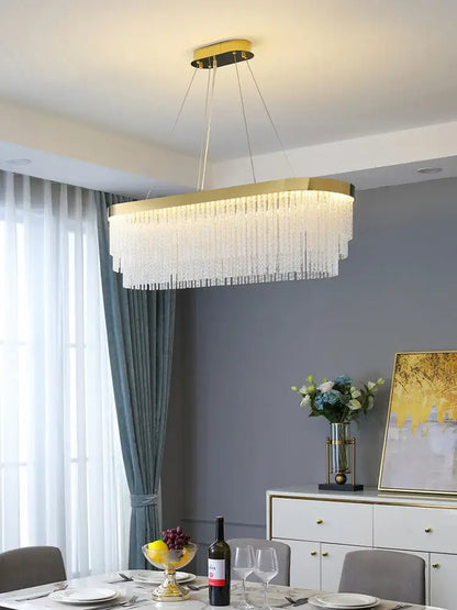 Modern gold crystal ceiling chandelier with rectangular frame and cascading clear crystal strands pendant light for dining room decorbites