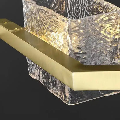 Modern gold crystal ceiling chandelier with gold-toned rectangular bar featuring textured glass and swirling patterns