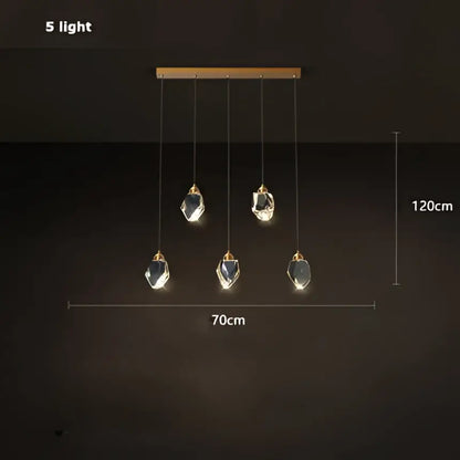 Modern gold crystal copper round chandelier with five lights, sleek wooden bar, and hanging crystal pendants for dining room decorbites crystal copper