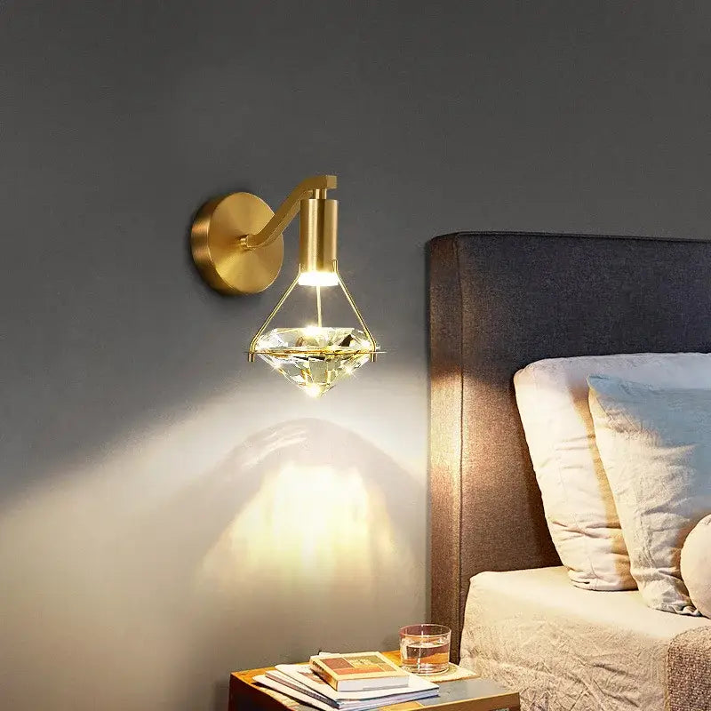 Modern gold-toned wall lamp with decorbites crystal diamond faceted shade for luxury bedroom lighting decor