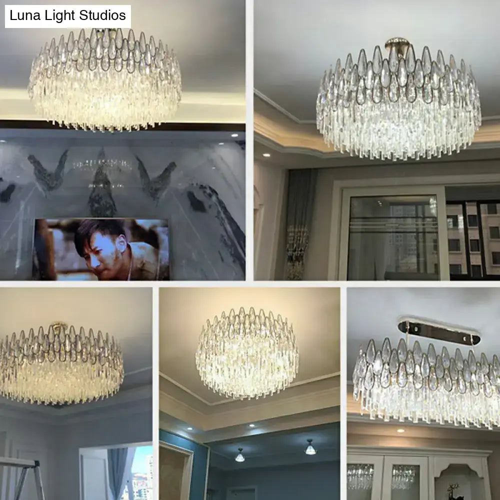 A modern DecorBites™ minimalist crystal drum pendant light with clear teardrop crystals for living room use