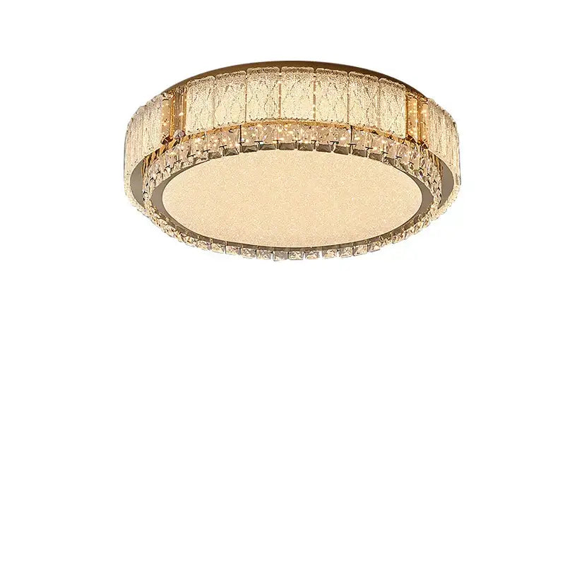 Modern gold-toned light fixture featuring decorbites crystal glass with textured diffuser and crystal glass ceiling accents