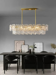 Modern gold crystal glass led pendant chandelier with a rectangular metal frame and cascading flower-like elements