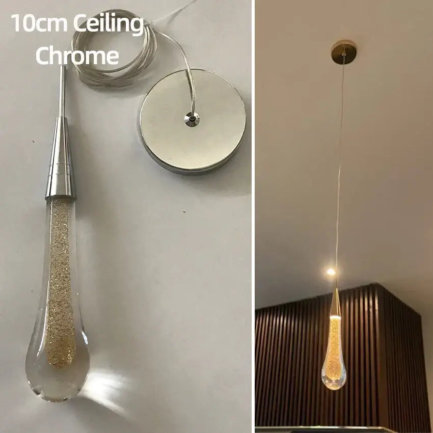 A 10cm chrome pendant light with a clear teardrop crystal glass led shade filled with golden glitter for dining room decorbites crystal glass