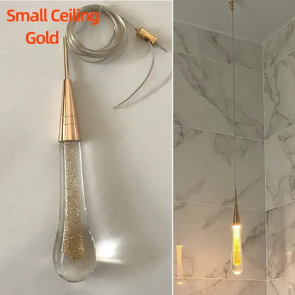 Modern gold crystal glass led pendant lights featuring a teardrop shade filled with golden glitter for dining room decorbites