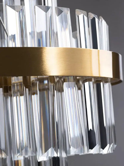 A modern gold crystal hanging lamp with clear faceted prisms on a sleek metal ring by decorbites crystal hanging