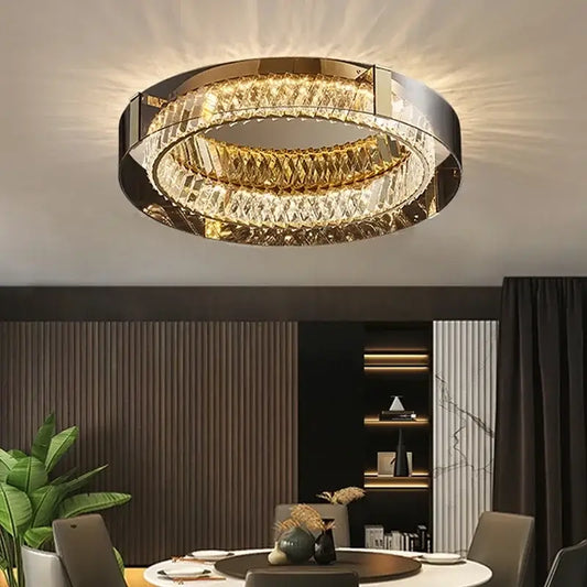 Modern gold crystal led ceiling chandelier featuring concentric faceted crystal rings in polished metal frames