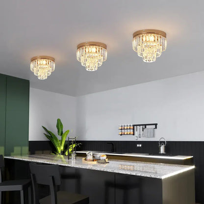Three elegant modern gold crystal led ceiling chandeliers with glass prisms for dining room lighting