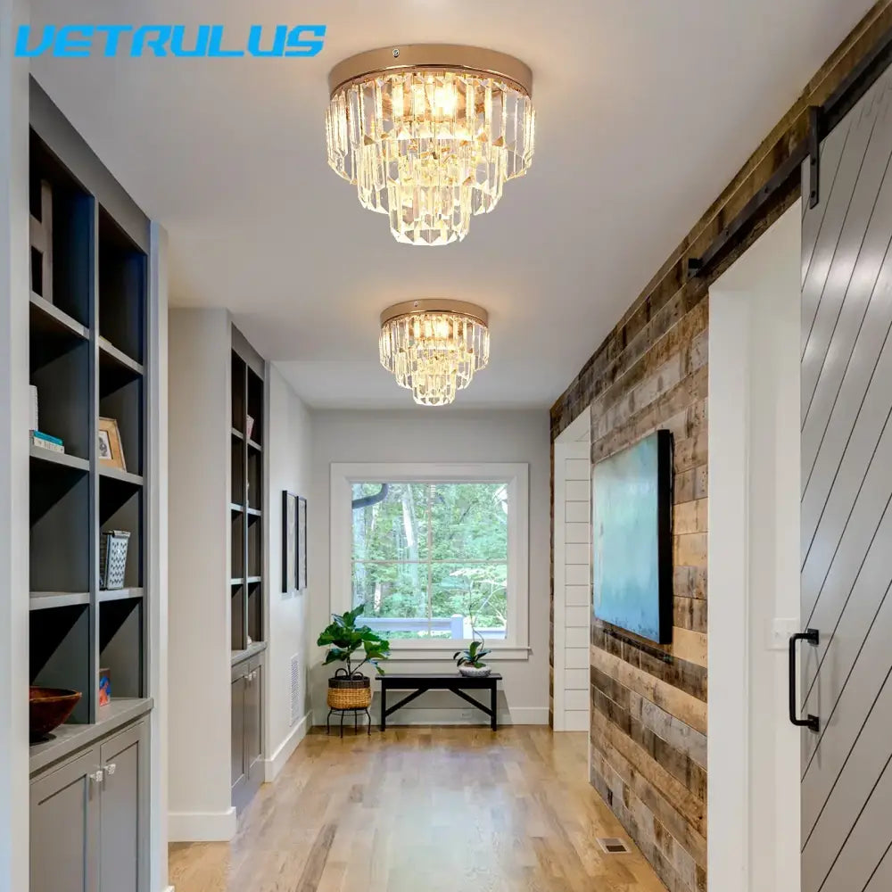 Two elegant modern gold crystal led ceiling chandeliers with cascading clear faceted crystals for dining room