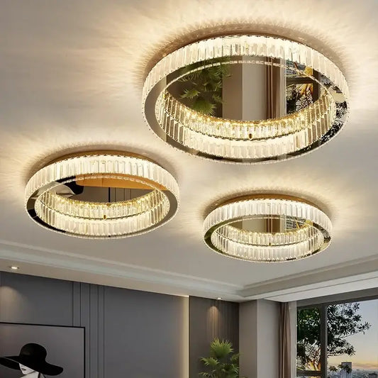 Three elegant modern gold crystal led ceiling chandeliers with circular frames and cascading faceted glass decorbites crystal led