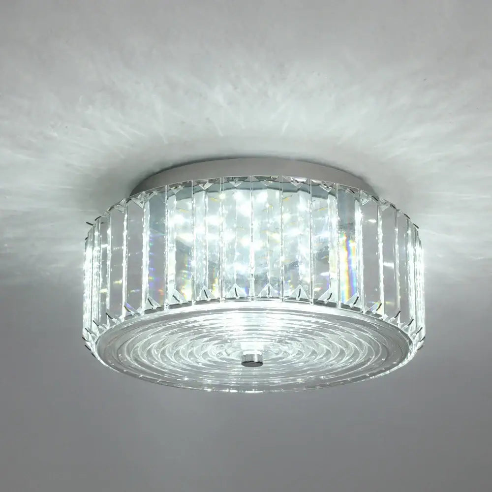 Modern gold crystal led ceiling chandelier with sleek chrome base and clear faceted glass prisms in concentric rings