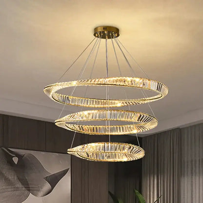 Modern gold crystal led chandelier with three concentric spiraling rings and faceted crystals by decorbites crystal led