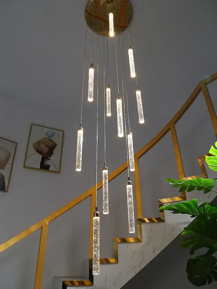 Modern gold crystal led chandelier with vertical crystal encrusted rods hanging from a circular brass fixture decorbites crystal led
