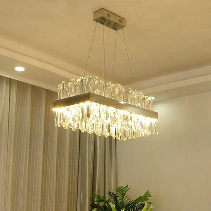 Modern gold crystal led pendant light featuring a rectangular frame with hanging glass prisms for elegant decorbites crystal led pendant lighting
