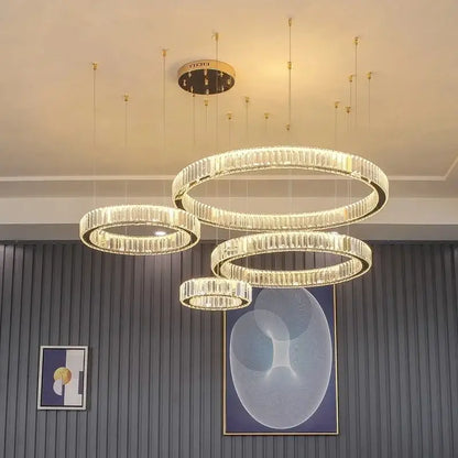 Modern gold crystal led ring chandelier with multiple concentric rings of faceted crystals on sleek metal frame