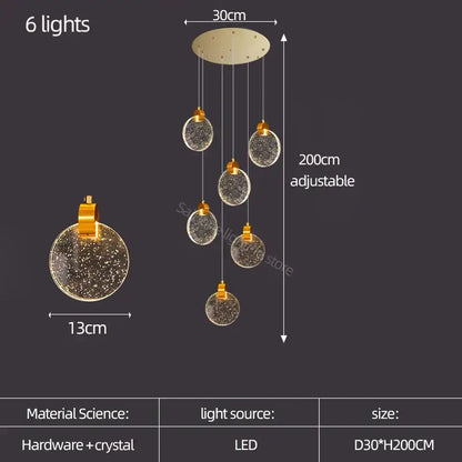A modern gold crystal led stair slinglight pendant light with six spherical glass orbs and decorbites crystal led interiors