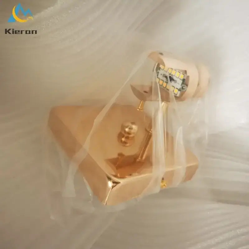 Gold-colored modern wall lamp with crystal led and angled cylindrical head for decorbites crystal led wall lighting