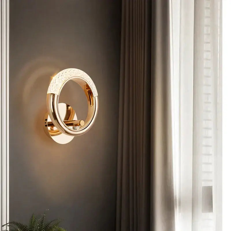Modern gold crystal led wall lamp featuring a circular textured outer ring and polished metallic inner band for living room use