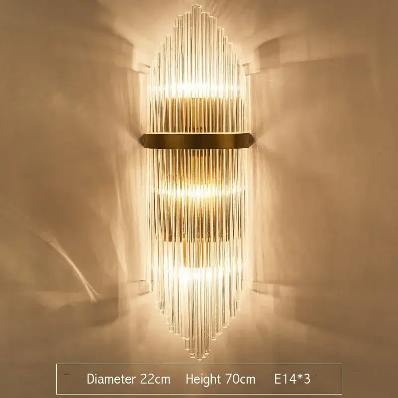 Modern gold crystal led wall sconce featuring vertical glass rods and metal accents for bedroom lighting