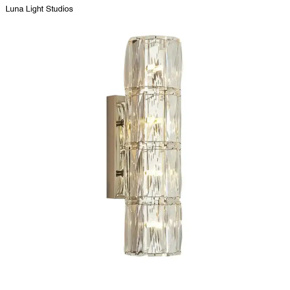 Modern gold crystal linear wall light with clear faceted segments and brushed brass backplate for dining room use