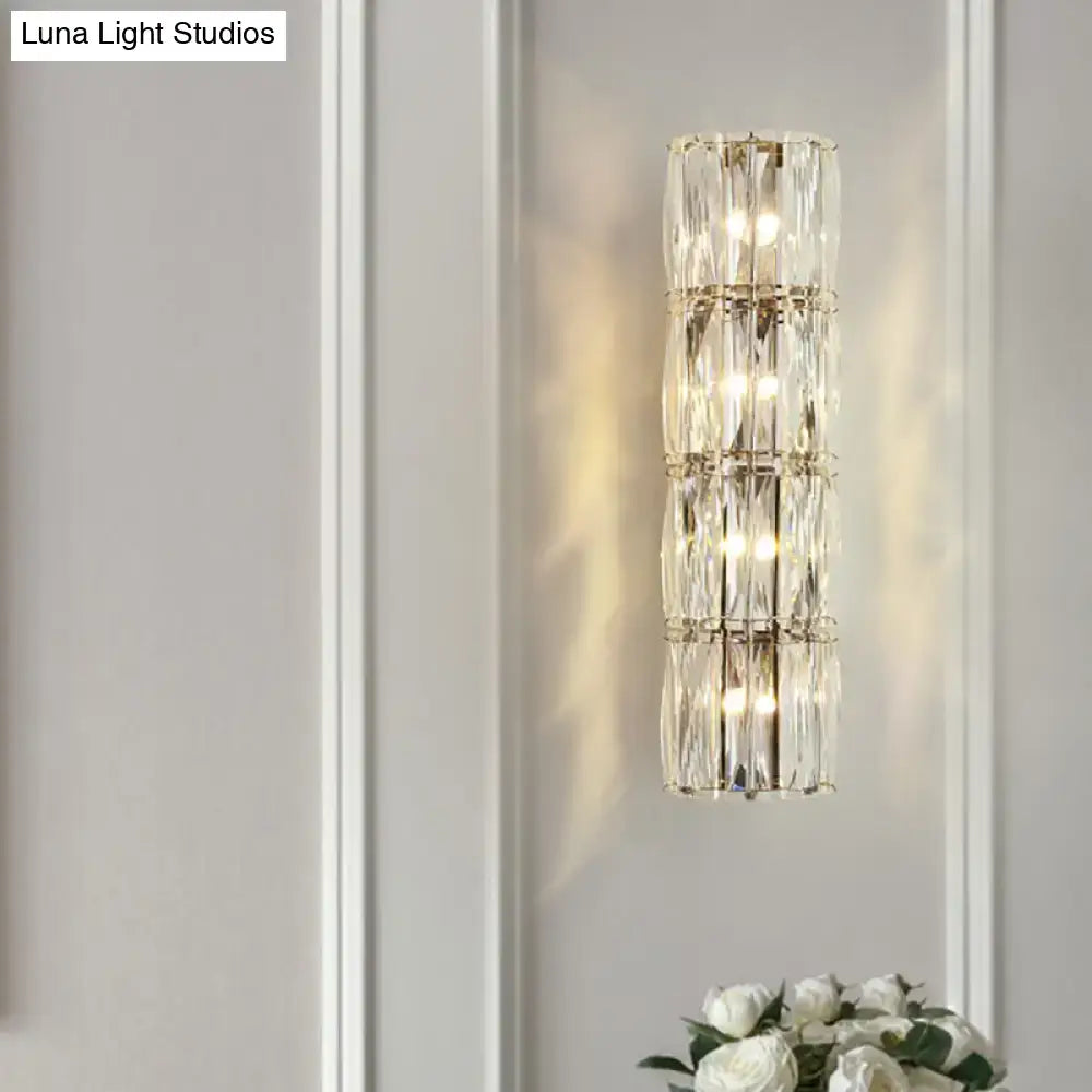 Modern gold crystal linear wall light with stacked clear prisms in polished metal for dining room use