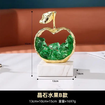 Modern gold crystal metal fruit sculpture set featuring a hollow apple with green stones on marble base for living room decor