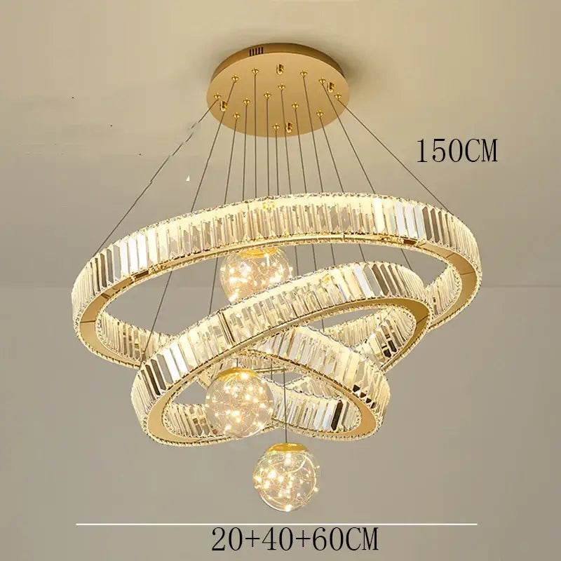Modern gold pendant light with three interlocking crystal rings and brushed stainless finish for dining room use