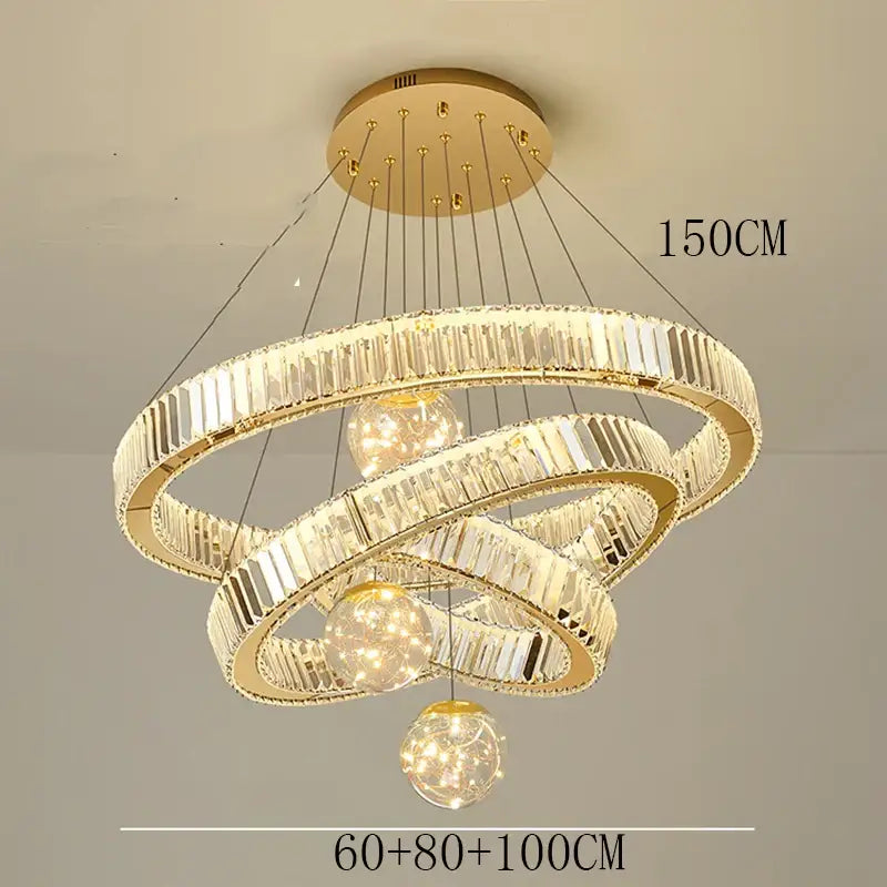 Modern gold crystal pendant light with three interlocking rings and brushed stainless finish for dining room use