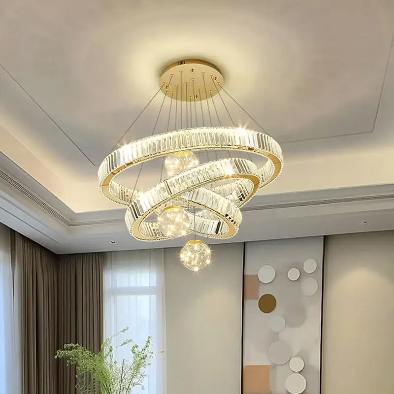 Modern gold crystal multi ring pendant light with brushed stainless finish featuring interlocking rings for dining room use