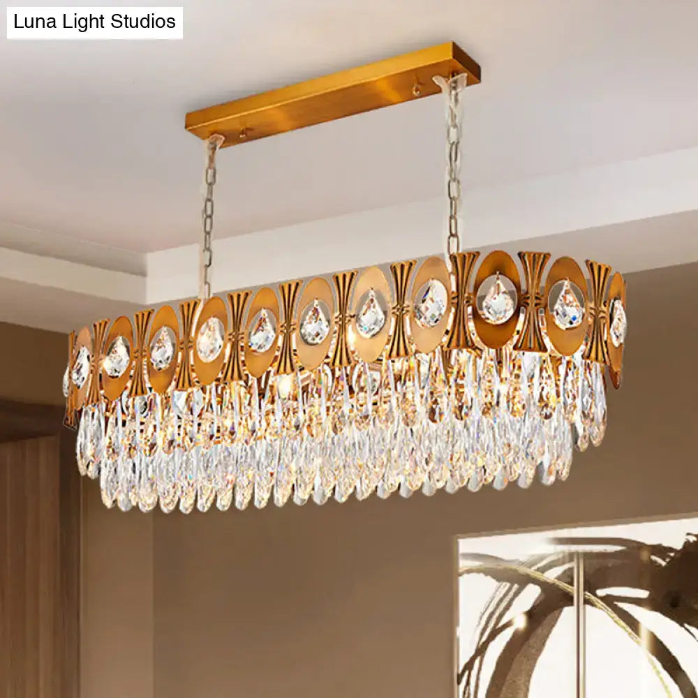 Modern gold crystal oval suspension island pendant light with gold-toned geometric cutouts and crystal teardrops