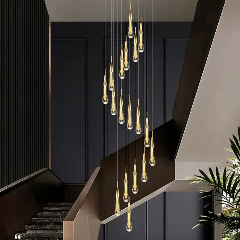 Modern gold crystal raindrop pendant lights featuring golden teardrop-shaped clear glass with metallic accents for foyer chandelier