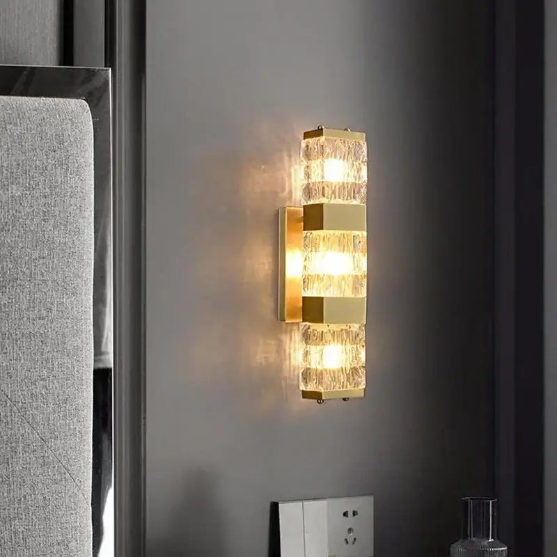 Modern gold crystal rectangle wall lamp featuring textured stacked glass panels emitting a warm glow for luxury decorbites crystal rectangle lighting