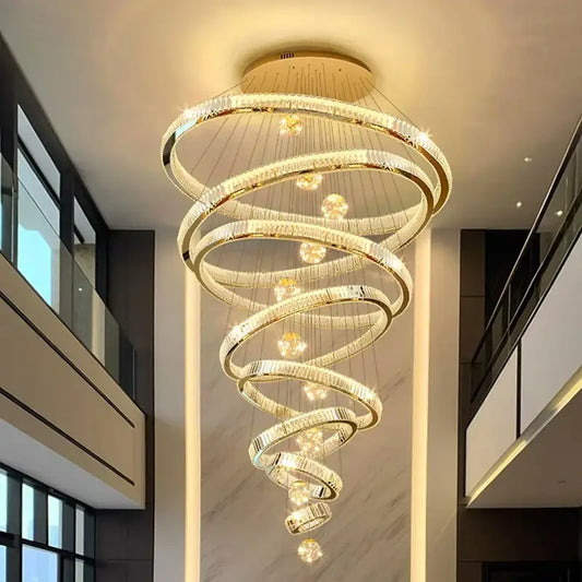 Modern gold crystal ring pendant light with metallic finish and concentric rings for staircase or dining room lighting