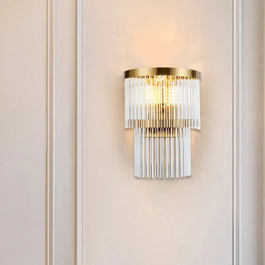 Modern gold wall lamp with cascading clear crystal rods for elegant dining room lighting