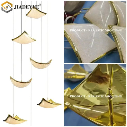 Modern gold crystal sand staircase chandelier featuring gold-finished crescent pendant lights with frosted glass centers