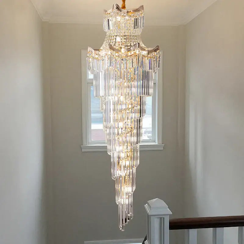 Modern gold crystal stair chandelier with cascading clear glass prisms and gold-toned metal accents by decorbites crystal stair