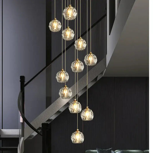 Modern gold crystal stair football shaped chandelier with multiple faceted crystal globe lights suspended by chains