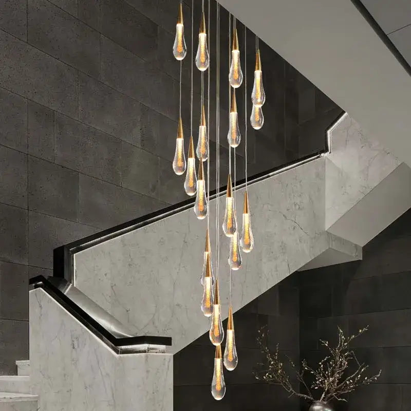 Modern gold crystal teardrop chandelier with multiple glass pendants and warm light for staircase or living room decorbites crystal teardrop