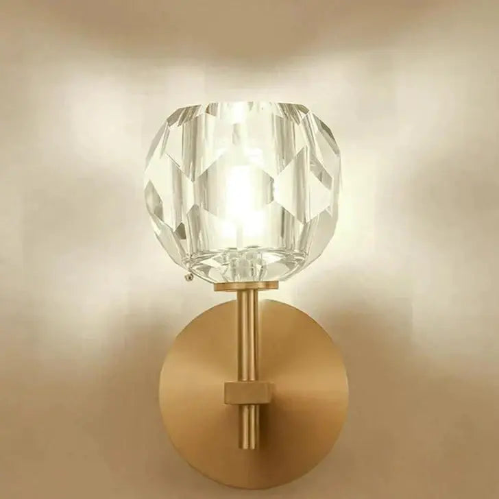 Decorbites ivy crystal wall lamp with faceted crystal globe on brushed brass stem and circular backplate wall lamp
