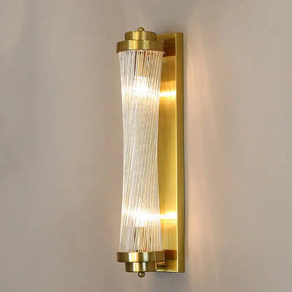 Modern gold crystal wall lamp with cylindrical glass rods and vertical translucent ribbons for warm bedroom lighting decorbites crystal wall lamp