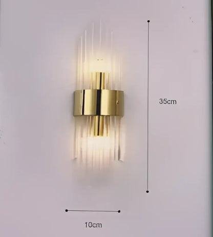 Modern gold crystal wall lamp with vertical glass tubes and a central cylindrical fixture for bedroom decorbites crystal wall lamp