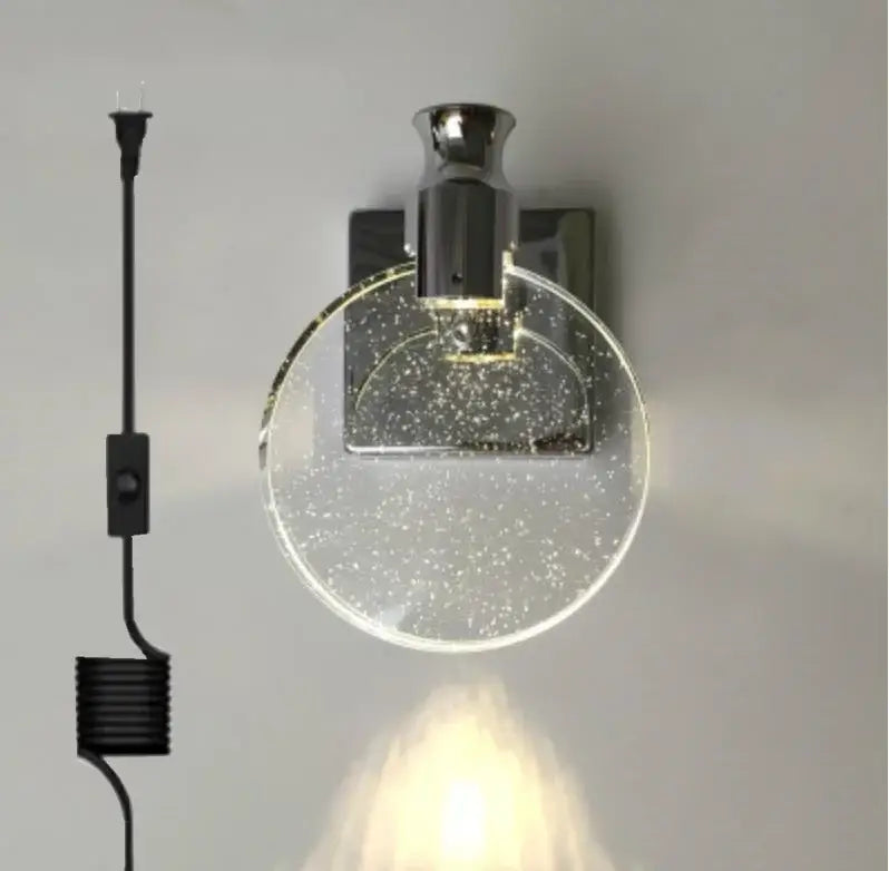 Modern chrome-finished wall lamp with a circular clear glass shade and embedded glitter particles for decorbites crystal wall use