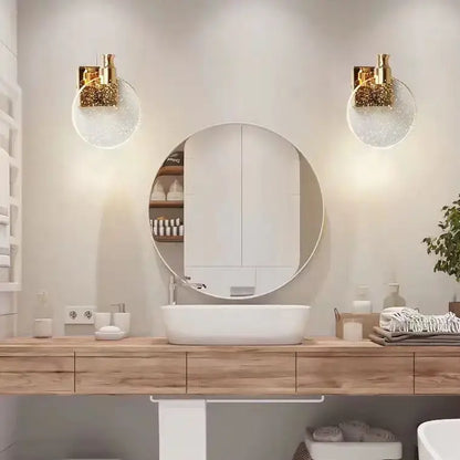 Modern gold crystal wall lamp with clear glass globe sconces flanking a round mirror for elegant wall decorbites crystal wall use