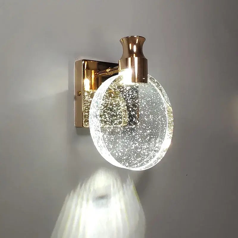 Modern gold crystal wall lamp with a metal base and bubble-filled glass globe for living room decorbites crystal wall sconce