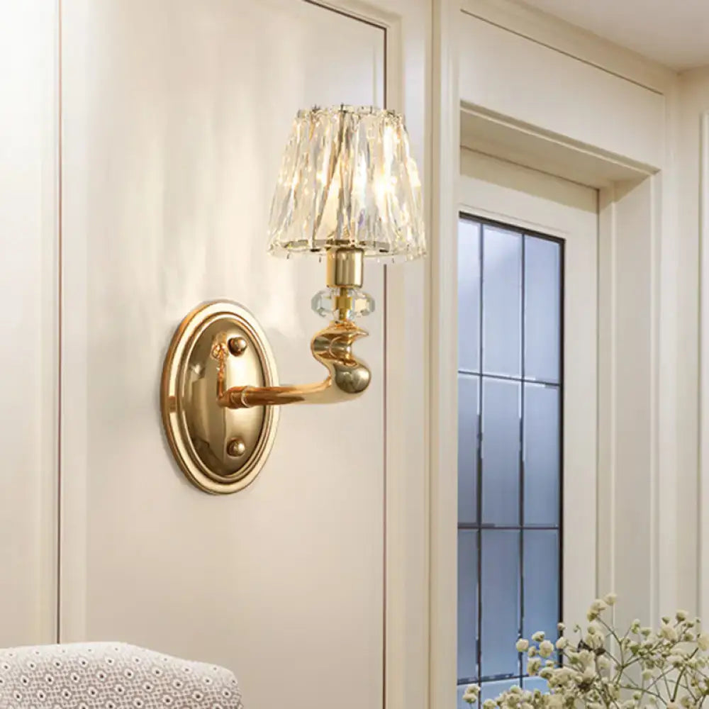 Modern gold wall light fixture with a crystal-encrusted lampshade for elegant bedroom lighting