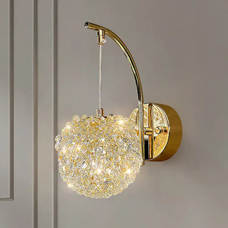 Modern gold crystal wall lights sconce with a spherical crystal-encrusted globe on an arched brass arm for bedroom decorbites crystal wall lighting