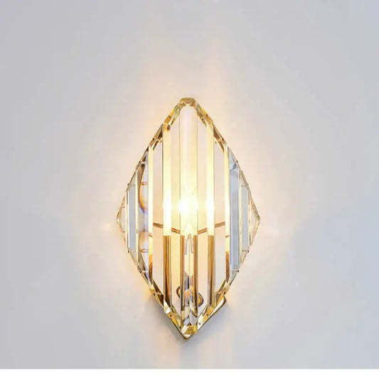Modern gold crystal wall sconce with clear faceted crystal panels and gold-toned metal framing for luxury decorbites crystal wall lighting