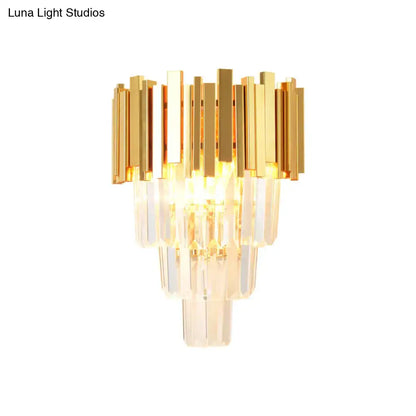 Modern gold crystal wall sconce with vertical bars featuring a gold-toned frame and clear crystal for living room use